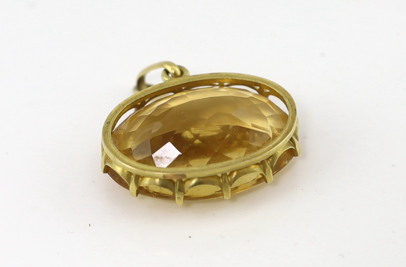 A large gold mounted oval cut citrine set pendant